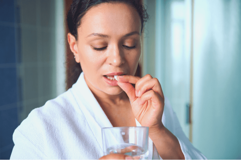 Woman taking multi vitamin