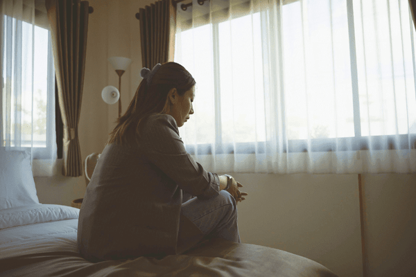 Woman sitting on bed