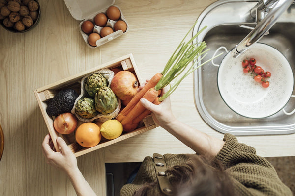 crate of fruits and vegetables in kitchen