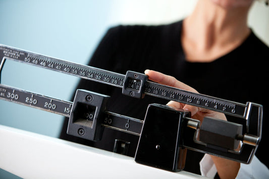 Woman on Scale Weighing Herself