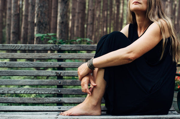 Woman sitting on bench outside