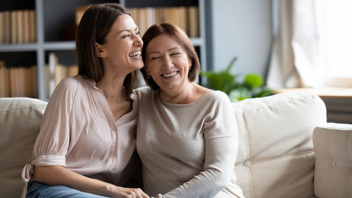 Women sitting on couch smiling