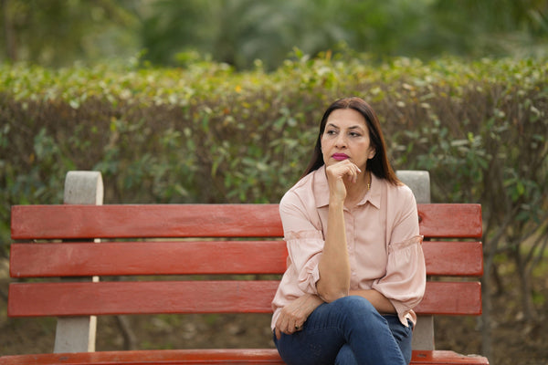 Woman sitting on a bench in spring 