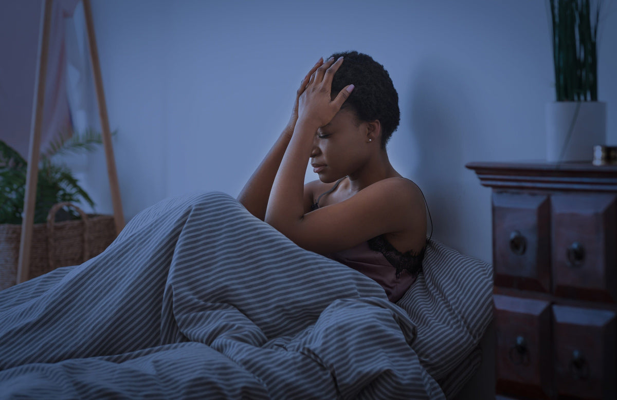 perimenopause woman awake in bed 