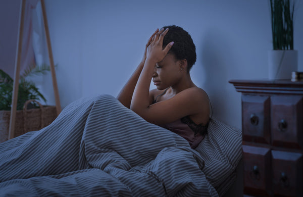 perimenopause woman awake in bed 