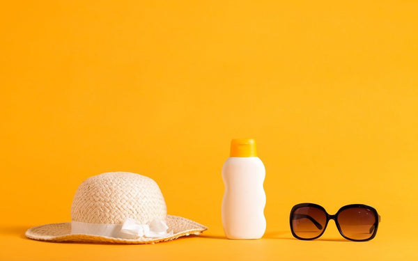 A sun hat, sunscreen, and sunglasses