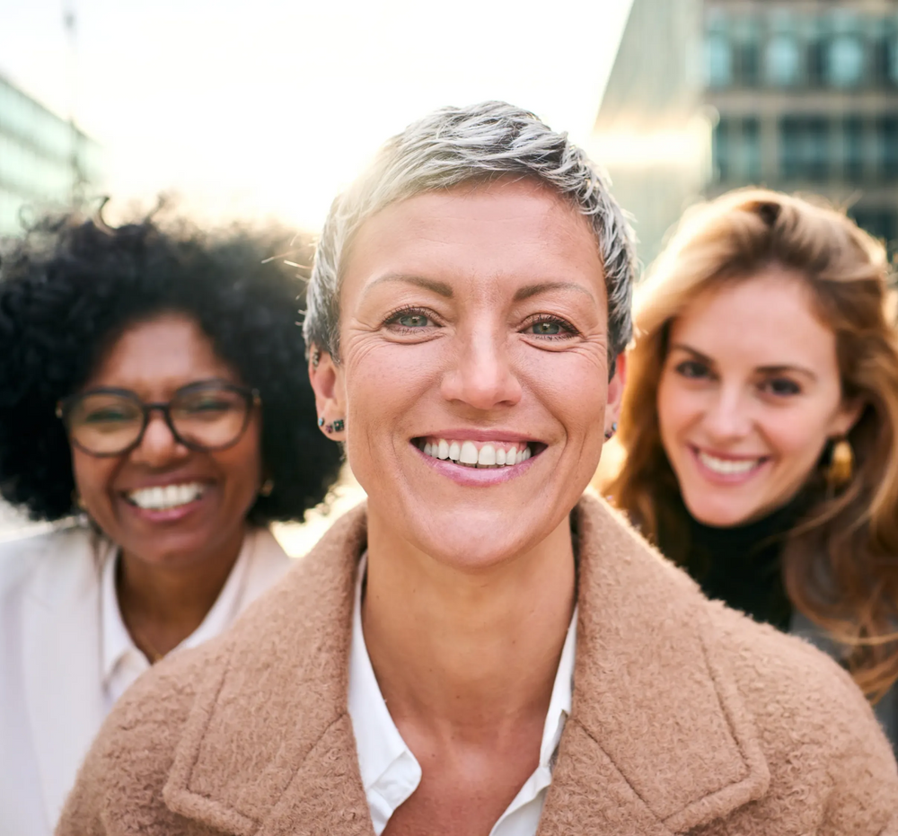 Three women smiling